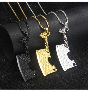 Detailed view of punk skull cleaver pendants in black, gold, and silver stainless steel