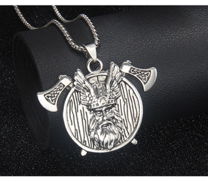 Macro view of Viking double axe warrior necklace with aged steel finish and wing details