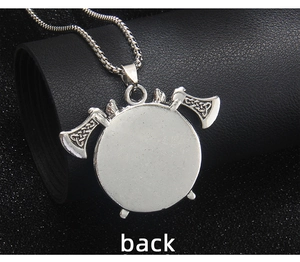 Macro view of the back of a vintage silver Viking double axe shield pendant necklace
