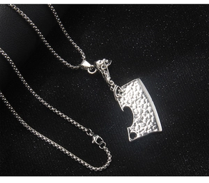 Macro view of stainless steel cleaver pendant with unique hammered texture and chain