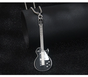 Gros plan détaillé du pendentif guitare avec émail noir et chaîne en métal argenté