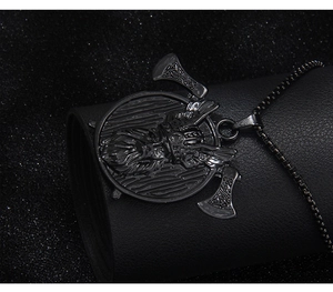 Detail view of a Viking warrior pendant with double axes on a black leather display