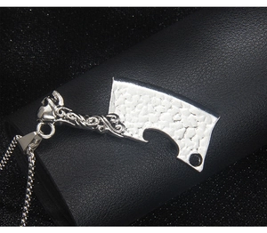 Detailed macro view of punk stainless steel skull knife pendant with intricate engravings