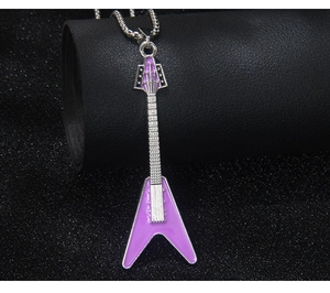 Macro detail of a purple enamel guitar pendant on a silver stainless steel necklace chain