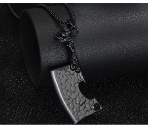 Macro view of punk skull cleaver pendant with hammered texture and black ball chain