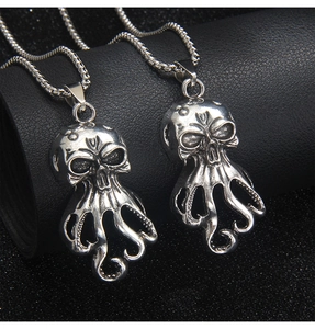 Close-up of vintage stainless steel octopus skull pendant with detailed tentacles on leather
