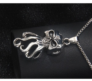 Detailed close-up of retro silver octopus skull pendant with textured tentacle details