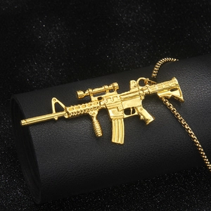 Golden machine gun pendant necklace with detailed rifle design and long bead chain