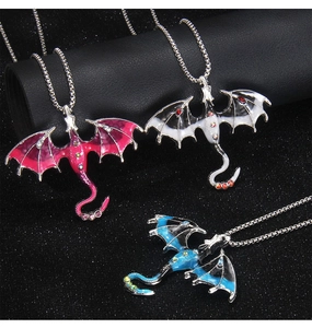 Detailed macro view of three gothic dragon pendants with enamel finish and crystal rhinestones