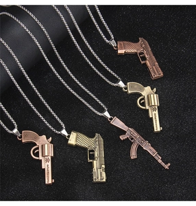 Detailed macro view of vintage bronze pistol pendants with engraved defeat the enemy text