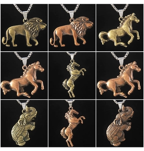Detailed view of vintage lion, horse, and elephant pendants in bronze and gold finish