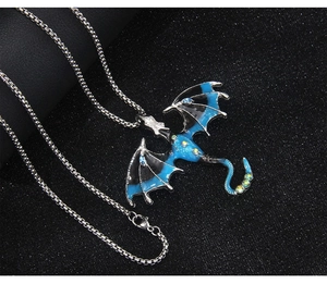 Macro detail of dragon pendant with blue enamel and rhinestones on stainless steel chain