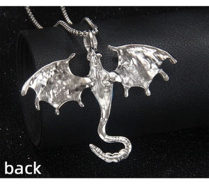 Macro detail of the rugged silver dragon pendant back with textured gothic bat wings