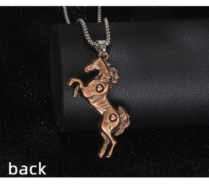 Macro view of the back of a vintage bronze horse pendant with a stainless steel chain