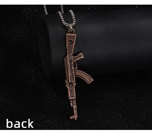 Detailed back view of vintage bronze AK-47 pendant with silver beaded chain necklace