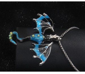 Detailed macro view of the silver dragon pendant with blue enamel and crystal accents