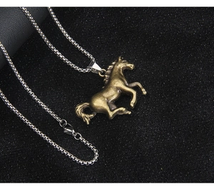 Macro detail of a vintage jumping horse pendant on a silver box chain necklace