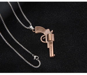 Detail of bronze revolver pendant with skull icon and defeat the enemy engraving