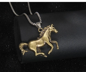 Detailed macro view of vintage bronze horse pendant with intricate muscle texture