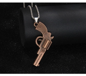 Detailed macro view of bronze revolver pendant with skull design and defeat the enemy text