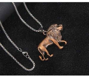 Detailed view of vintage lion head pendant in antique bronze on a steel chain for men