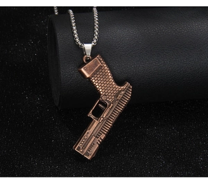 Close-up of bronze pistol pendant showing the P2020 engraving and honeycomb texture
