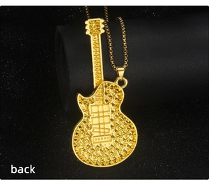 Detailed back view of gold guitar pendant with textured conical relief and chain