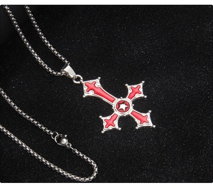 Close-up of gothic inverted cross necklace with red enamel and silver star detail