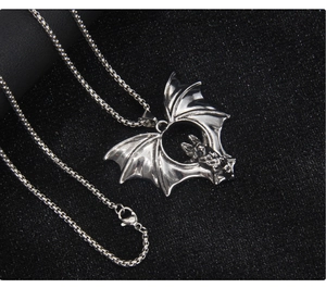 Macro shot of gothic bat pendant in silver finish with detailed square box chain