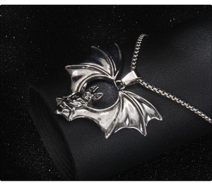 Detailed close-up of dark gothic bat pendant in polished silver stainless steel