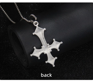 Macro detail of the radial texture on the back of the gothic inverted cross necklace