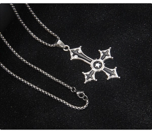 Close-up of gothic stainless steel inverted cross pendant with black oil and pentagram