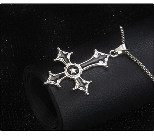 Macro detail of Gothic stainless steel inverted cross necklace with black enamel inlay
