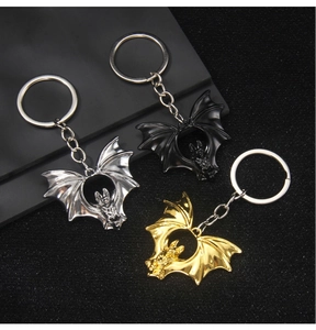 Detailed trio of vintage gothic bat keychains in silver, black, and gold metal finishes