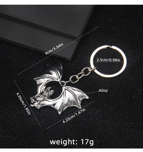 Macro shot of silver alloy bat keychain showing detailed dimensions and wings