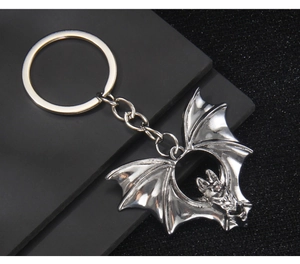 Detailed view of gothic silver bat keychain with intricate wing textures and metal chain