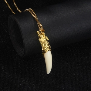 Golden dragon head wolf tooth pendant necklace for men with beaded chain on black background