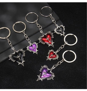 Gothic heart cross keychains in black, red, and purple with thorny metal edges