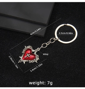 Gothic punk keychain with a red heart, silver cross, and intricate rose relief details