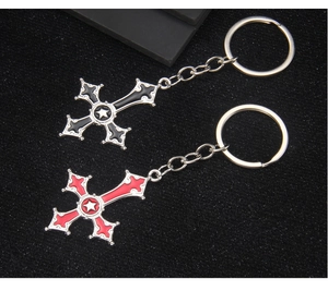 Detail of gothic cross keychains with black and red enamel and white pentagram stars