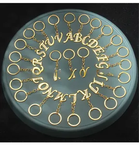 Set of 26 gold-plated alphabet keychains with sparkling white rhinestones on display