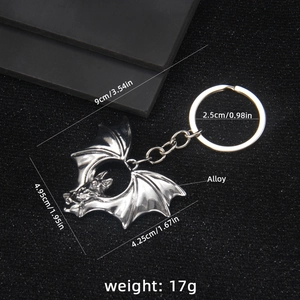 Silver gothic bat keychain made of alloy with detailed size measurements and dark aesthetic