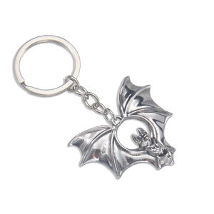 Vintage silver bat keychain with detailed wings and gothic style on white background