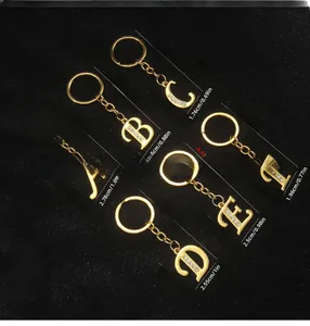 Detail of alphabet keychains with crystal rhinestones showing product dimensions and weight
