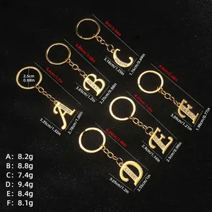 Golden alloy alphabet keychains A to F set with white rhinestones on black texture