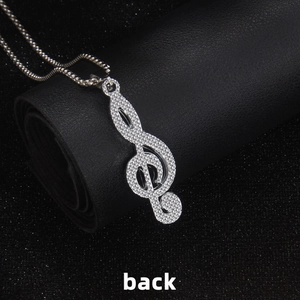 Silver treble clef musical note pendant necklace with box chain on black texture