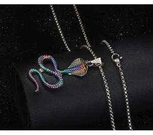 Macro shot of iridescent rainbow cobra pendant on a stainless steel box chain necklace