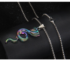Close-up of rainbow stainless steel cobra pendant with detailed scale textures on black