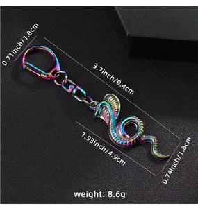 Detail view of iridescent cobra keychain showing 9.4cm length and 8.6g weight specs