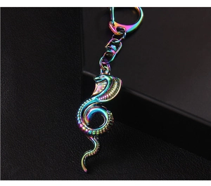 Macro detail of iridescent cobra snake keychain showing rainbow plating on metal